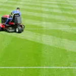 Lawn mower creating alternating stripes on a green field