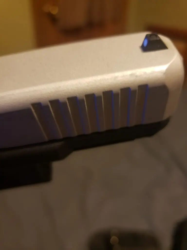 Close-up of burnishing on Cerakoted slide serrations in H-151 Satin Aluminum - caused by holster wear